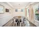 Airy dining room with stylish decor, including an elegant chandelier, white drapes, and a decorative mirror at 635 R L Stowe Rd, Belmont, NC 28012