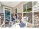 Inviting front porch with rocking chairs, blue cushions, and a table, creating a cozy outdoor space at 635 R L Stowe Rd, Belmont, NC 28012