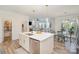 Open kitchen with stainless appliances, island, and sightlines to the dining area and living room at 635 R L Stowe Rd, Belmont, NC 28012