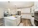 Spacious kitchen featuring white cabinetry, stainless steel appliances, a center island, and open layout at 635 R L Stowe Rd, Belmont, NC 28012
