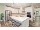 Modern kitchen with stainless steel appliances, a large center island, white cabinets, and stylish pendant lighting at 635 R L Stowe Rd, Belmont, NC 28012