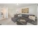 Comfortable living room with a large gray sectional, ottoman and stylish decor, offering a relaxing space at 635 R L Stowe Rd, Belmont, NC 28012