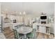 Open-concept living space with kitchen, dining area, and living room featuring a fireplace at 635 R L Stowe Rd, Belmont, NC 28012