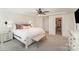 Bright main bedroom with a walk-in closet, tray ceiling and carpet flooring throughout at 635 R L Stowe Rd, Belmont, NC 28012