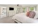 Comfortable main bedroom with a white dresser, a mounted TV and a door leading to the main bath at 635 R L Stowe Rd, Belmont, NC 28012