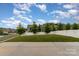 The fenced backyard has a manicured lawn, young trees, and ample space for entertaining and recreation at 732 Altamonte Dr, Clover, SC 29710