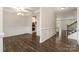 Open-concept dining room with dark wood floors, modern light fixture, and detailed wall trim at 732 Altamonte Dr, Clover, SC 29710