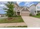 Charming two-story home with a well-manicured lawn, a two-car garage, and mature landscaping at 732 Altamonte Dr, Clover, SC 29710
