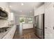 Well-lit kitchen featuring granite countertops, stainless appliances, white cabinets and dark wood floors at 732 Altamonte Dr, Clover, SC 29710