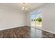 Bright living room with dark wood floors, light walls, modern light fixture and a sliding glass door leading outside at 732 Altamonte Dr, Clover, SC 29710
