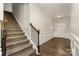 Carpeted staircase leading to the upper floor, complemented by dark wood handrail and a view of the entry hallway at 732 Altamonte Dr, Clover, SC 29710