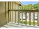A view from the balcony looks out to the parking lot and is surrounded by tall green trees at 7912 Charter Oak Ln, Charlotte, NC 28226