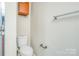 Bathroom featuring a toilet and mounted cabinet at 7912 Charter Oak Ln, Charlotte, NC 28226