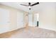 Bedroom featuring neutral walls, carpet, and access to a bathroom at 7912 Charter Oak Ln, Charlotte, NC 28226