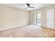 Bedroom with beige carpet, ceiling fan, closet and door to balcony at 7912 Charter Oak Ln, Charlotte, NC 28226