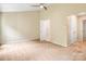 Bedroom featuring neutral walls, carpet, ceiling fan, and bathroom access at 7912 Charter Oak Ln, Charlotte, NC 28226