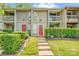 Inviting townhome with well-manicured front yard and vibrant red doors at 7912 Charter Oak Ln, Charlotte, NC 28226