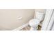 A minimalist toilet next to a wall mounted paper holder and faux hardwood flooring at 7912 Charter Oak Ln, Charlotte, NC 28226