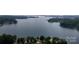 Expansive aerial shot of waterfront property with lush trees and serene lake views at 8112 Blackwood Rd, Denver, NC 28037