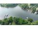 Aerial view of a lake and homes with boat docks surrounded by lush trees at 8112 Blackwood Rd, Denver, NC 28037