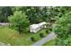 Aerial view of home with a detached garage and surrounded by mature shade trees at 8112 Blackwood Rd, Denver, NC 28037