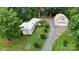 Aerial view of home with a detached garage, mature trees, and a long driveway at 8112 Blackwood Rd, Denver, NC 28037