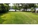 Spacious backyard overlooking the lake with lush green grass and mature trees at 8112 Blackwood Rd, Denver, NC 28037