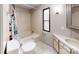 Bathroom with a tub/shower combo, tile floors, and a window for natural light at 8112 Blackwood Rd, Denver, NC 28037