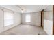Bright bedroom with neutral carpet, two windows, and a ceiling fan at 8112 Blackwood Rd, Denver, NC 28037