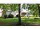 Exterior of home with a covered porch, green grass, and mature landscaping at 8112 Blackwood Rd, Denver, NC 28037