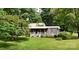 Charming home with a covered porch, lovely landscaping, and a lush green lawn at 8112 Blackwood Rd, Denver, NC 28037