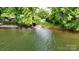 Lush land meeting a serene lake with a boat launch at 8112 Blackwood Rd, Denver, NC 28037