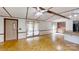 Open layout featuring wood-look floors, ceiling fan, and a view of the outdoor deck at 8112 Blackwood Rd, Denver, NC 28037
