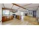 Cozy open living space with a stone fireplace and eat-in kitchen bar at 8112 Blackwood Rd, Denver, NC 28037