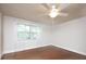 A bedroom showcasing hardwood floors, neutral walls, window with blinds, and modern ceiling fan at 848 Woodland Rd, Statesville, NC 28677