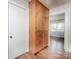 Hallway with wood floors, built-in cabinets and doorway to another room at 848 Woodland Rd, Statesville, NC 28677
