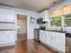 Updated kitchen featuring white cabinets, granite countertops, and stainless steel appliances at 848 Woodland Rd, Statesville, NC 28677