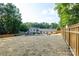 Beautiful backyard with a brand new fence, in-ground pool, a gazebo covered seating area, and lush trees at 932 Shady Bluff Dr, Charlotte, NC 28211