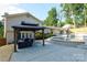 Beautiful backyard with a gazebo covered seating area overlooking a stunning pool with natural rock features at 932 Shady Bluff Dr, Charlotte, NC 28211