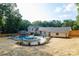 Landscaped backyard featuring an in-ground pool with patio, a gazebo covered seating area, and a manicured lawn at 932 Shady Bluff Dr, Charlotte, NC 28211