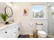 Bright bathroom with a bear picture and window offering a view of trees and a marble shower at 932 Shady Bluff Dr, Charlotte, NC 28211