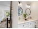 Stylish bathroom featuring double vanity with round mirrors and access to bedroom at 932 Shady Bluff Dr, Charlotte, NC 28211