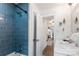 Bathroom featuring blue tiled shower and open view into the hallway at 932 Shady Bluff Dr, Charlotte, NC 28211