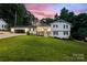 Charming two-story home with a well-manicured lawn, a covered front porch, and an attached two-car garage at 932 Shady Bluff Dr, Charlotte, NC 28211