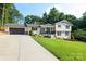 Attractive home showcasing a long driveway leading to an attached garage and well-maintained front yard at 932 Shady Bluff Dr, Charlotte, NC 28211