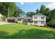 Charming home with a well-manicured lawn, attached garage, and inviting blue front door at 932 Shady Bluff Dr, Charlotte, NC 28211