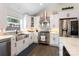 Kitchen boasts stainless appliances, white cabinetry, and a large sink with bright light at 932 Shady Bluff Dr, Charlotte, NC 28211