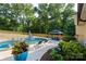 Backyard oasis with swimming pool, hot tub, patio furniture, and lush landscaping at 932 Shady Bluff Dr, Charlotte, NC 28211