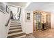 View of stairs leading to a climate controlled wine cellar with custom wooden racks and lighting at 932 Shady Bluff Dr, Charlotte, NC 28211