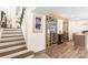 Stairway leading to a custom designed wine cellar complete with cooler and glass rack storage at 932 Shady Bluff Dr, Charlotte, NC 28211